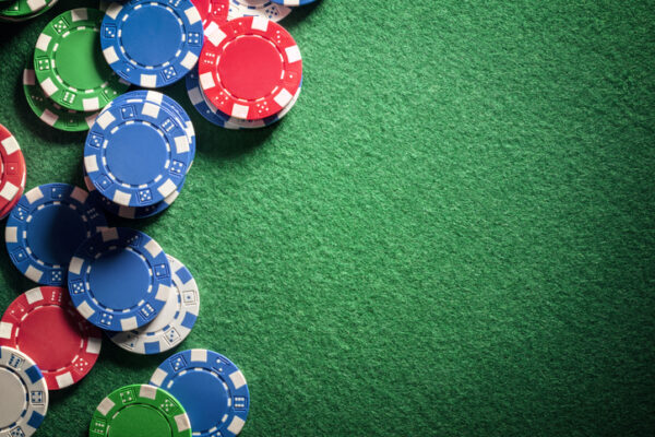 Poker chips laying on green casino table