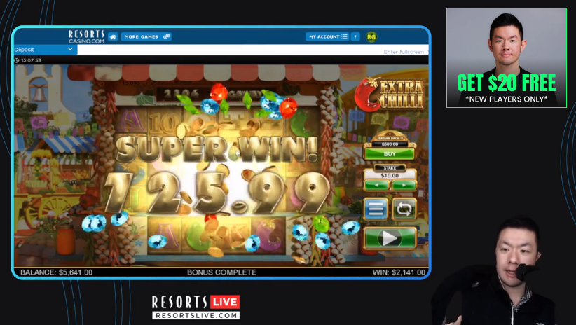 An image of a resort live Kevin yen. 
There is a man on the bottom right, there's a screen of a live slot game extra chilli. 