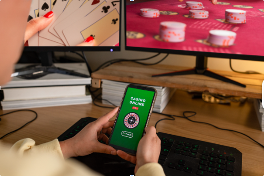 zoomed in image of a person holding a phone playing online casino games