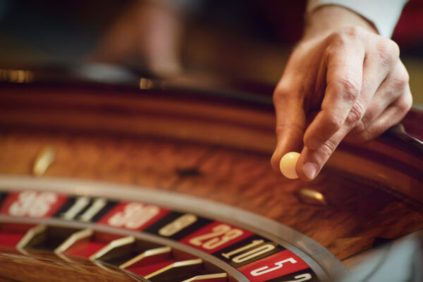 Hand of a croupier on a roulette whell in a casino. Roulette betting poker. Gambling in a casino., roulette handout