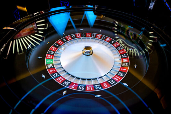 An image of roulette odds, a neon casino