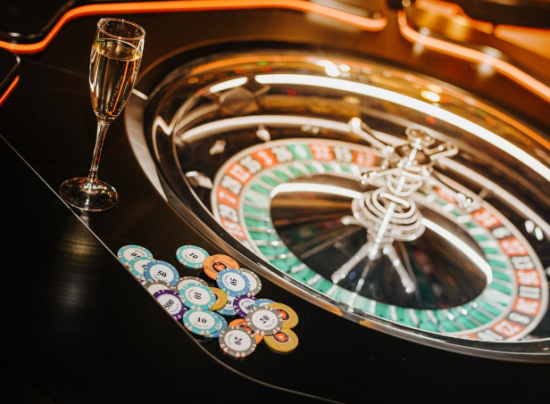 An image if a roulette in casino with chips on the side