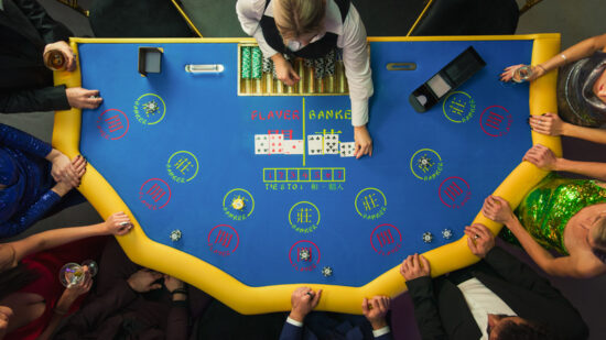 View Of Glamorous Casino Gamblers Placing Bets using the golden baccarat strategy